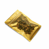 Top view of  a sealed matte gold flat pouch with nuts inside