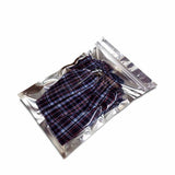 Silver flat pouch with zip lock used to pack shorts