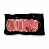 Black vacuum bag used to pack raw pork chops