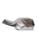 Side view of an aluminum gusset bag lying on its back