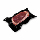 Iso view of a steak sealed in a black vacuum bag 